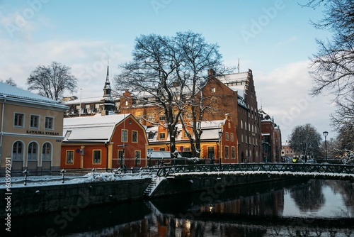 Winter scene of the city of Uppsala with a lake and colorful buildings in Sweden © Silentgene/Wirestock Creators