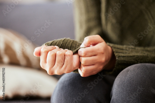 Hands, anxiety and closeup of a woman with depression, mental health problem and stress in home lounge. Female person on a couch for psychology, fear and abuse on a sofa while sad or depressed