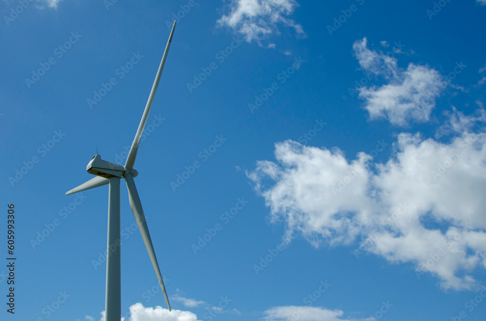 Windmill generating power on a cloudy day Windmill generating power on a cloudy day