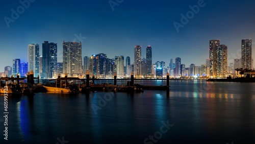 Beautiful scene of a modern city with high skyscrapers and buildings illuminated at night
