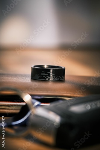 Vertical shot of a wedding ring with an Engraved battle scene