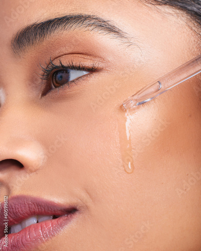 Beauty serum, woman and skincare closeup with dermatology and face cleaning. Wellness, hyaluronic acid and young female model with skin glow product and treatment with care and dropper in studio