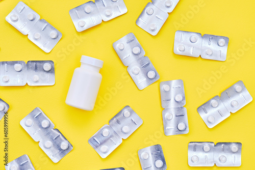 Antiparasitic drugs on yellow background. photo