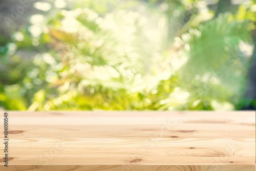 Blur Green Plant Garden Nature with Empty Wooden Floor Foreground for Eco Products Advertising Montage Background.