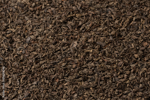 Dried tea leaves as a background.