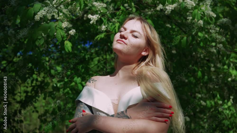 Beautiful blonde in a white wedding dress. Runaway Bride. Fear of weddings, breakup concept. Runs through the park from his fate. Beautiful blonde in a white wedding dress. Runaway Bride. Fear of weddings, breakup concept. Runs through the park from his fate.