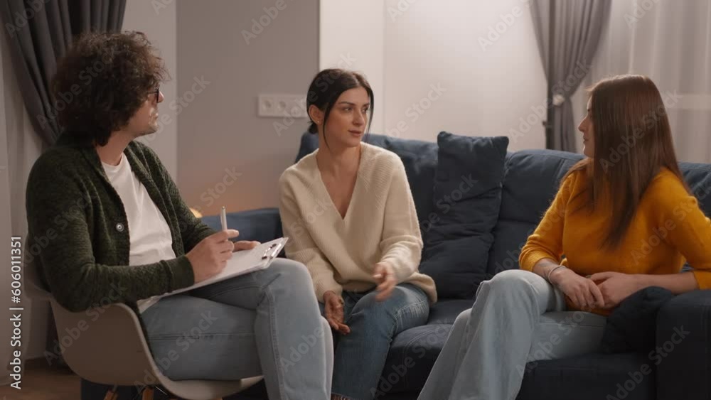 LGBT Same-sex couple talking psychologist at therapy session, relationship problems LGBT Same-sex couple talking psychologist at therapy session, relationship problems