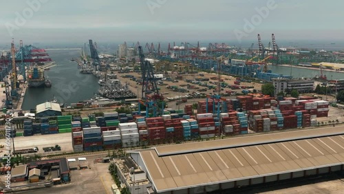 Sea port with container ships and cranes in the loading area. Tanjung Priok sea port. Indonesia. photo