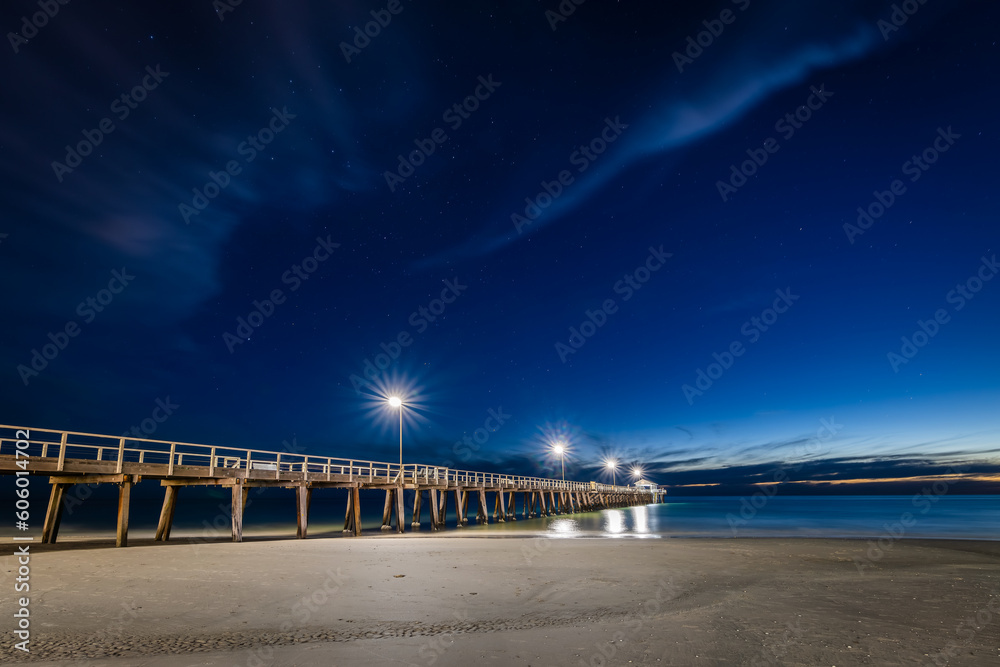 Henley Beach pier illuminated at night with starry sky above, South Australia