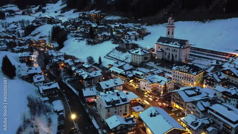 Drone shot of illuminated Sexten, Italy in a winter evening