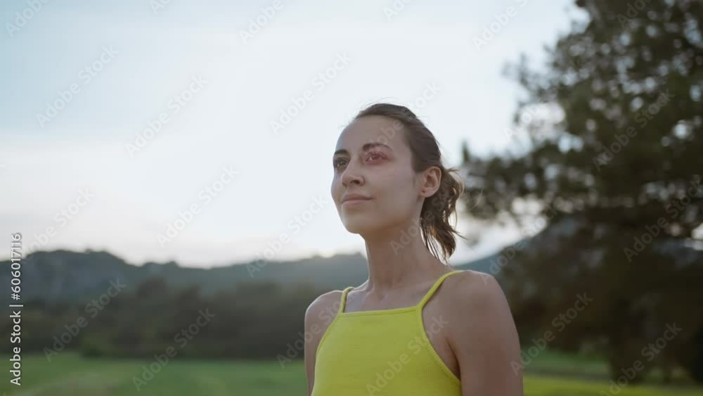 slow motion portrait of Young Athlete Woman enjoyinng beautiful green rural field landscape after running outdoors along Green Fields. slow motion portrait of Young Athlete Woman enjoyinng beautiful green rural field landscape after running outdoors along Green Fields.