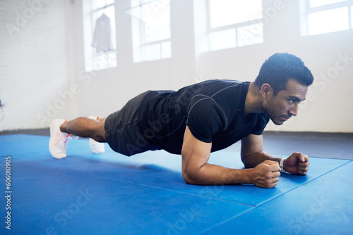 Sports, plank and fitness with man in gym for strong, workout and muscle. Exercise, power and health with male athlete and training on floor for wellness, abdominal challenge and balance