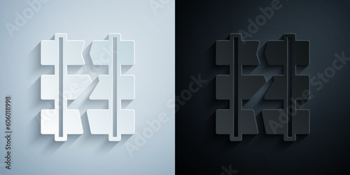 Paper cut Broken or cracked rails on a railway icon isolated on grey and black background. Paper art style. Vector