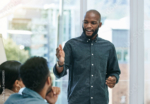 Presentation, planning and training with black man in business meeting for motivation, mentor and leadership. Teamwork, conference and speaker with employee in workshop for mission, project and idea