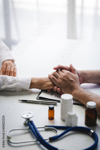 doctor holding patient s hand Cheer and encourage while checking your health. Trust your health and mind.