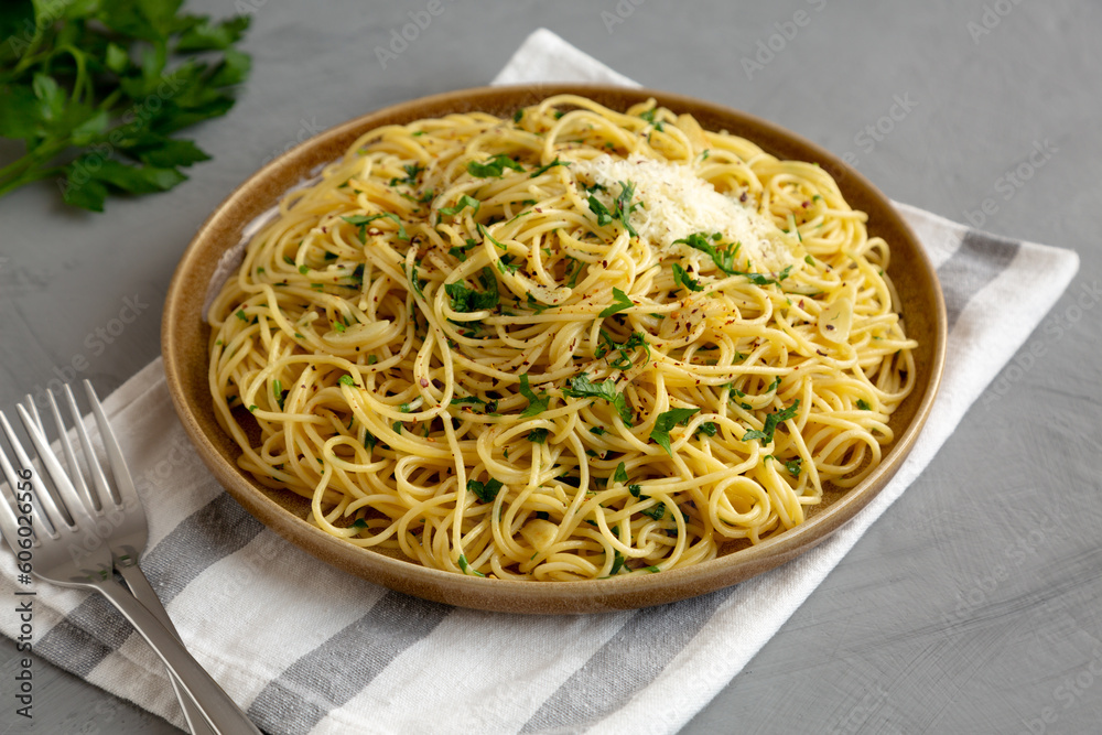 Homemade Italian Spaghetti Aglio e Olio on a Plate, side view.