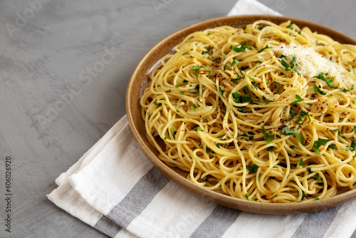 Homemade Italian Spaghetti Aglio e Olio on a Plate, side view. Copy space.