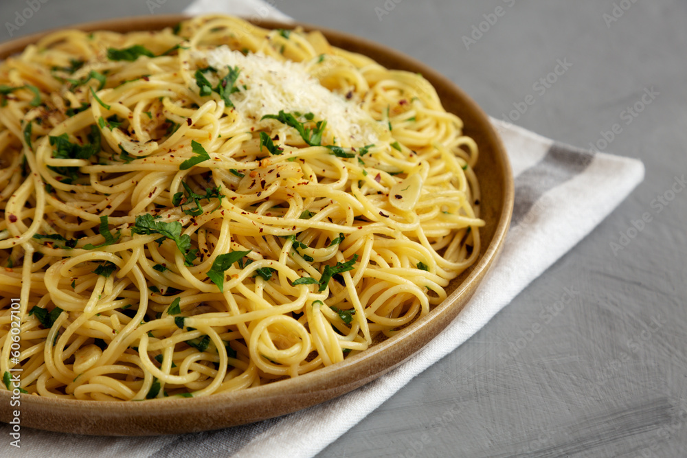 Homemade Italian Spaghetti Aglio e Olio on a Plate, side view. Copy space.