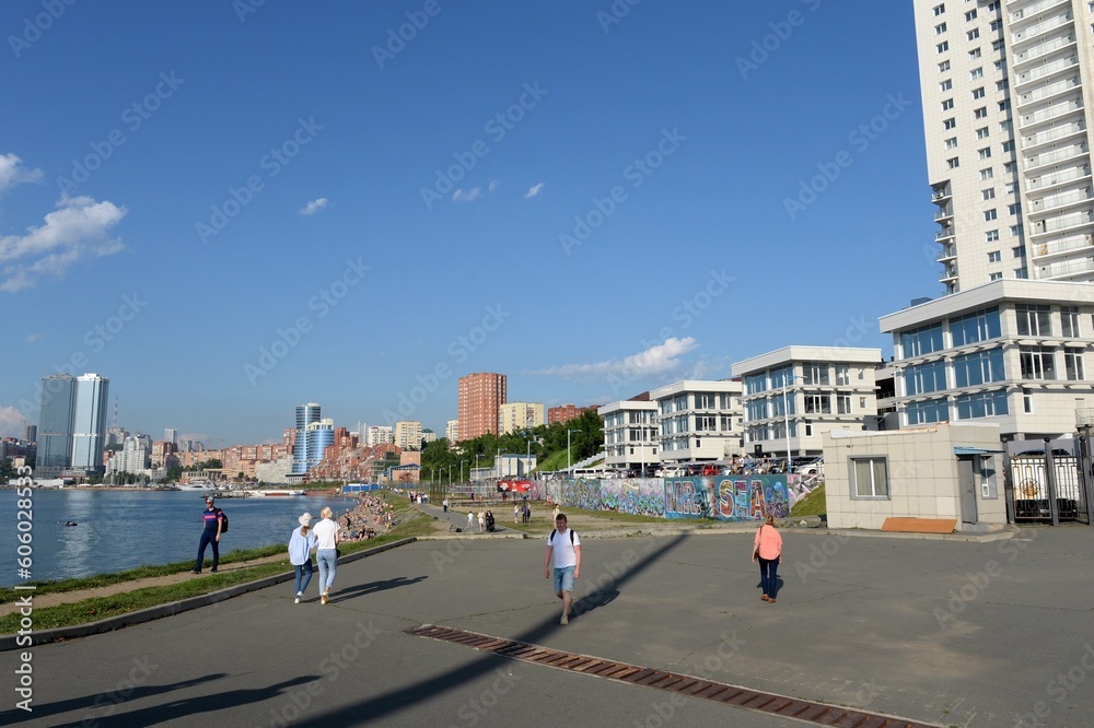 People walk on the shore of Fedorov Bay in Vladivostok