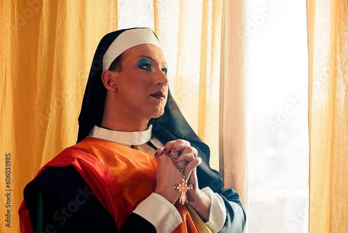 man dressed as a nun prays with the rosary in queer cross-dressing