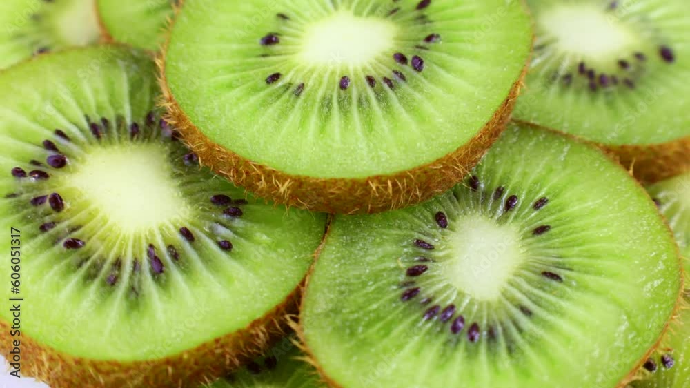 Bright green fresh kiwi slices rotation close up Bright green fresh kiwi slices rotation close up