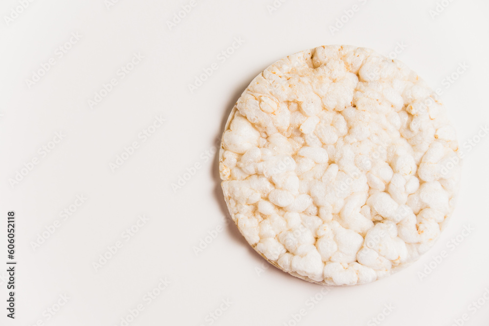 Delicious crispy puffed rice bread on white background with copy space. Diet and healthy eating concept.