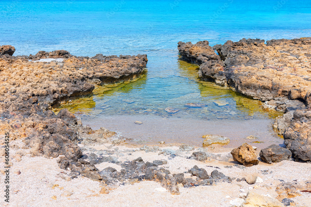 Rocky sea lagoon with turquoise water . Sea shore with stones by summer