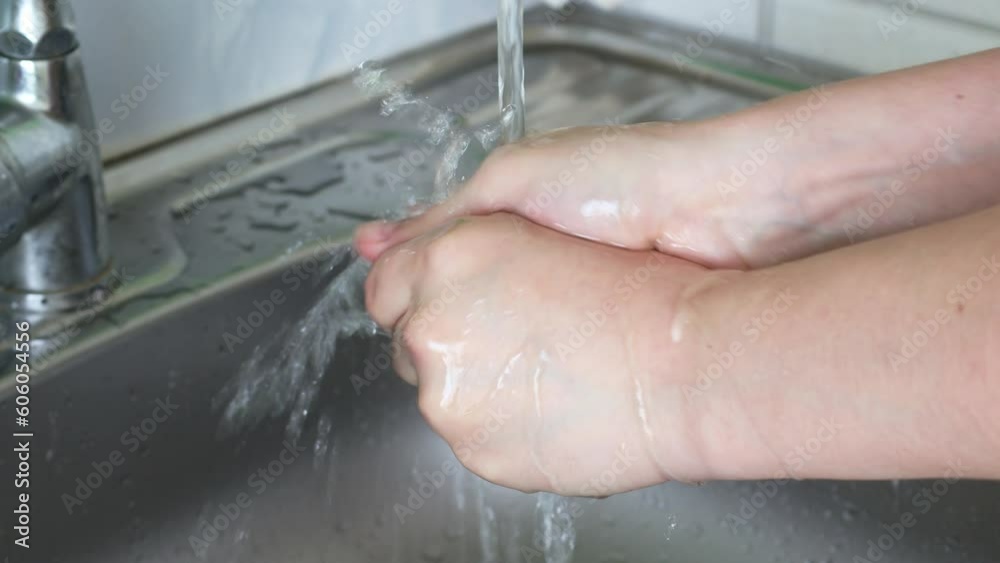 Caucasian woman washes hands with water close up Caucasian woman washes hands with water close up