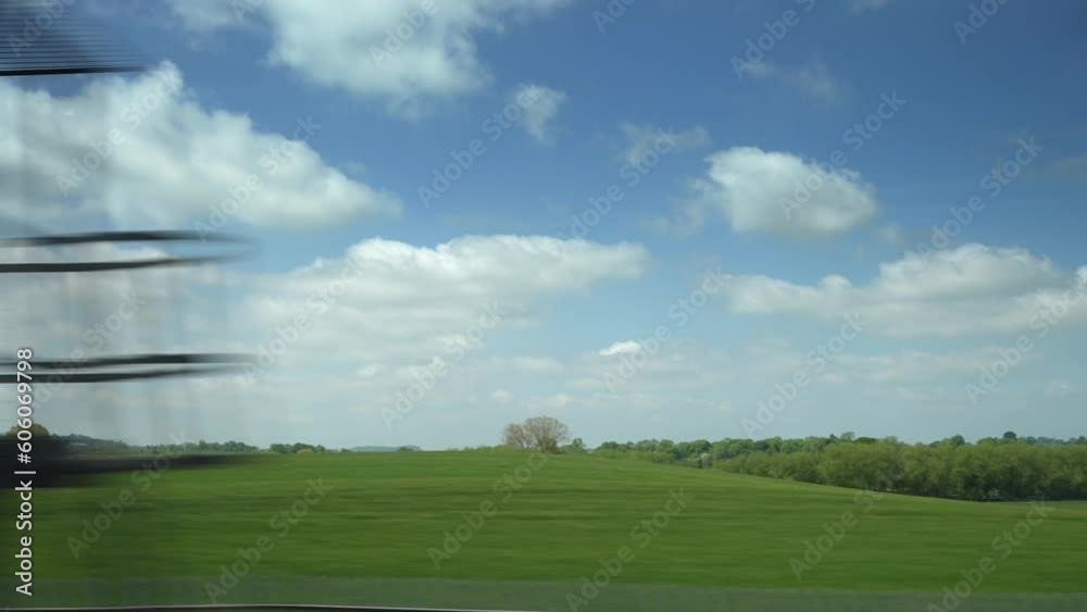 English countryside from a train window.
Fields and trees shot from a moving train window in the English Midlands.