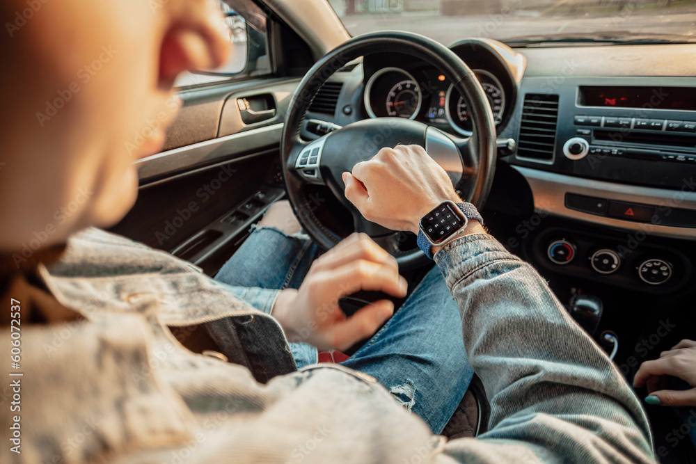 smart watch on the hand of car driver, close up. transport, business trip, technology, time and people concept smart watch on the hand of car driver, close up. transport, business trip, technology, time and people concept