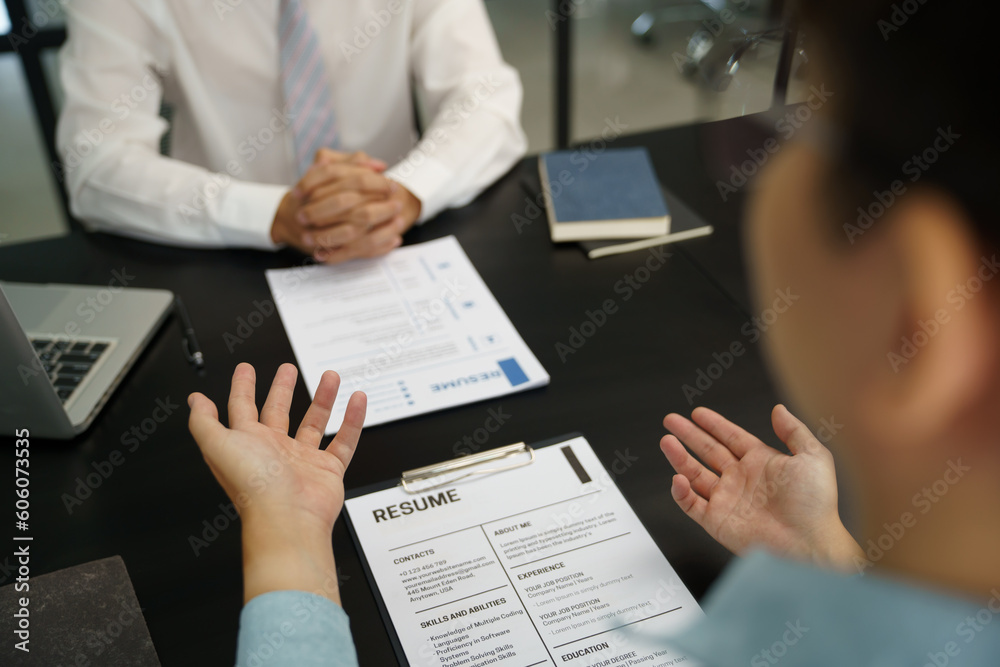 Team leader coach teach young workers explain on paper for business plan listen talkative coworker and discussing new project presentation Serious professional advisor consulting in office.