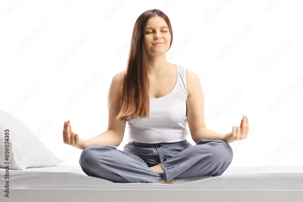 Young woman in pajamas sitting in a yoga pose