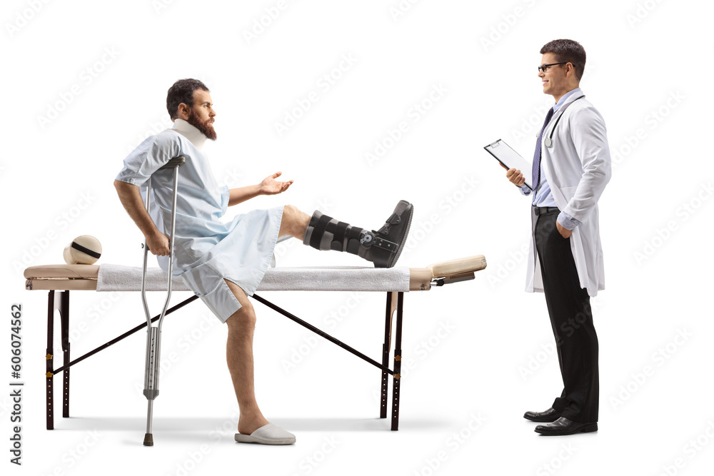 Patient with an orthopedic boot and neck collar sitting on a therapy table and talking to a therapist Patient with an orthopedic boot and neck collar sitting on a therapy table and talking to a therapist