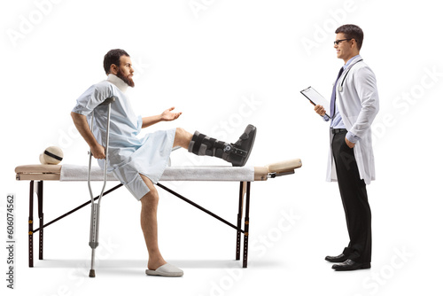 Patient with an orthopedic boot and neck collar sitting on a therapy table and talking to a therapist