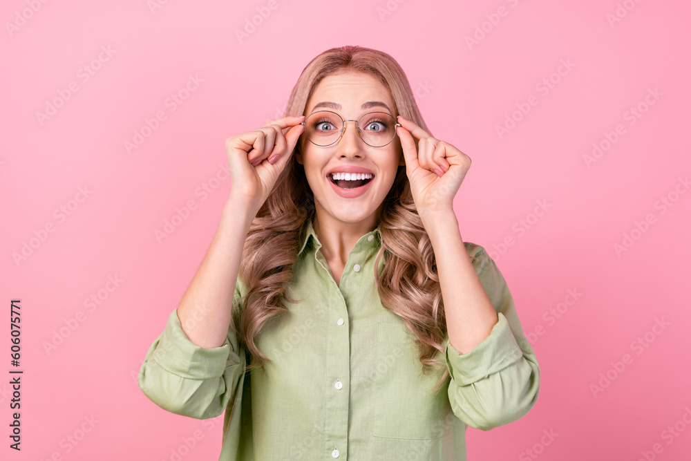 Photo of astonished nice person toothy smile hands touch glasses isolated on pink color background Photo of astonished nice person toothy smile hands touch glasses isolated on pink color background