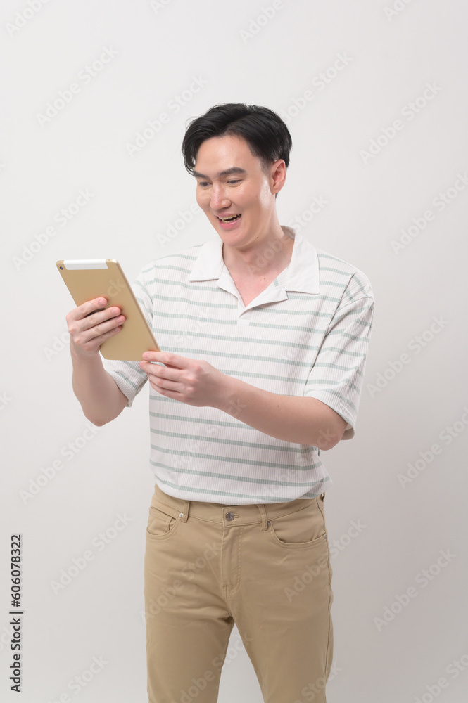Young asian man using tablet over white background, technology concept. . Young asian man using tablet over white background, technology concept. .