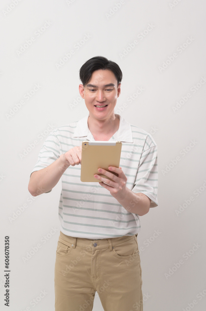 Young asian man using tablet over white background, technology concept. . Young asian man using tablet over white background, technology concept. .
