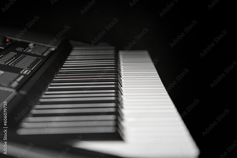 Keyboard synthesizer on a dark background. Electric piano close-up. Keyboard synthesizer on a dark background. Electric piano close-up.