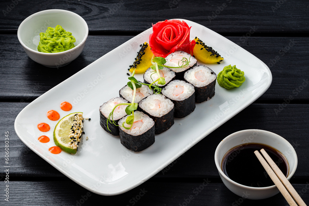 Set of sushi rolls from shrimps, cream cheese, rice and nori with wasabi, ginger and soy sauce. Set of sushi rolls from shrimps, cream cheese, rice and nori with wasabi, ginger and soy sauce.