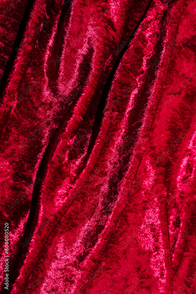 Fototapeta premium Texture of red velor corduroy fabric with folds.