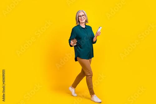 Photo of agent entrepreneur lady relax pause drink coffee using gadget network communication isolated shine color background © deagreez