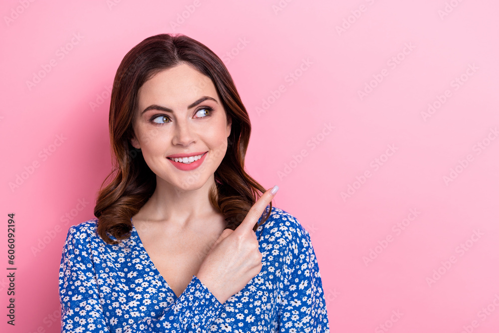 Photo of nice cute positive person beaming smile look indicate finger empty space isolated on pink color background Photo of nice cute positive person beaming smile look indicate finger empty space isolated on pink color background