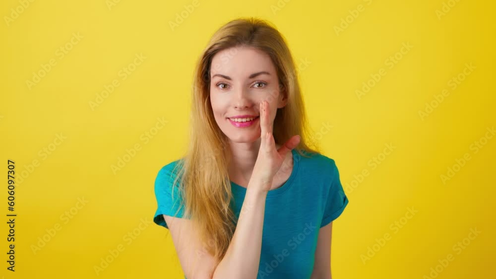 Secret, mystery and woman keeps index finger on lips, makes silence quiet shh gesture. Positive expression, confident smiling lady female looks around in studio isolated on yellow background. Secret, mystery and woman keeps index finger on lips, makes silence quiet shh gesture. Positive expression, confident smiling lady female looks around in studio isolated on yellow background.