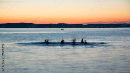 bathers in Lake Balaton at sunset