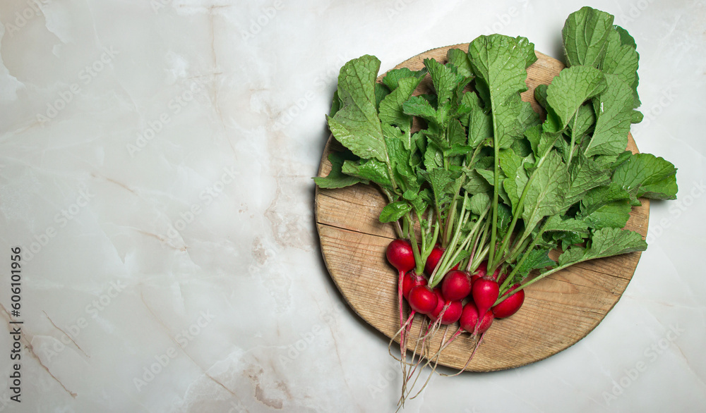 Radishes with tops on a wooden board. Fresh vegetables Radishes with tops on a wooden board. Fresh vegetables