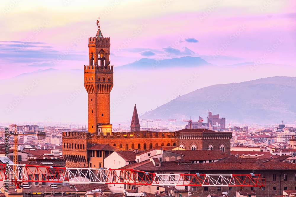 The view of the towers of the Palazzo Vecchio from Piazzale Michelangelo in Florence at sunset.