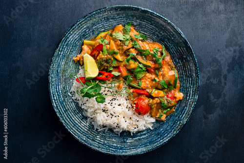 Chicken stew with tomatoes, sweet peppers, beans, zucchini, sauce and rice.