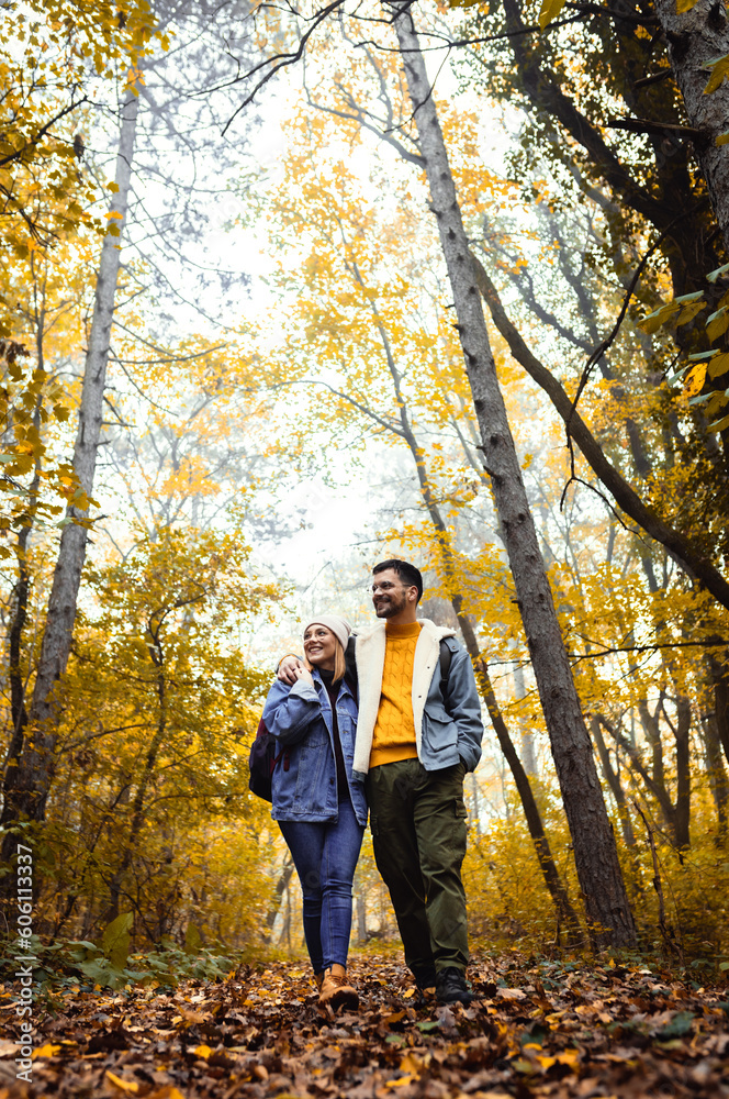 Portrait of couple spending time together walking in forest. Portrait of couple spending time together walking in forest.