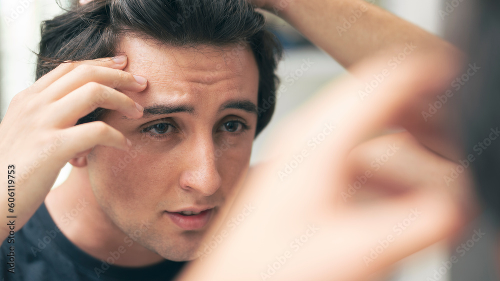 Man looking at his wrinkles in front of mirror Man looking at his wrinkles in front of mirror