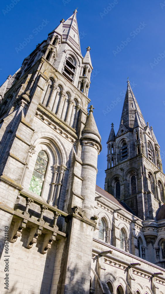 The tall Gothic spire of an Anglican church in Cork, Ireland. Neo-Gothic architecture. Cathedral Church of St Fin Barre, Cork - One of Ireland’s Iconic Buildings.